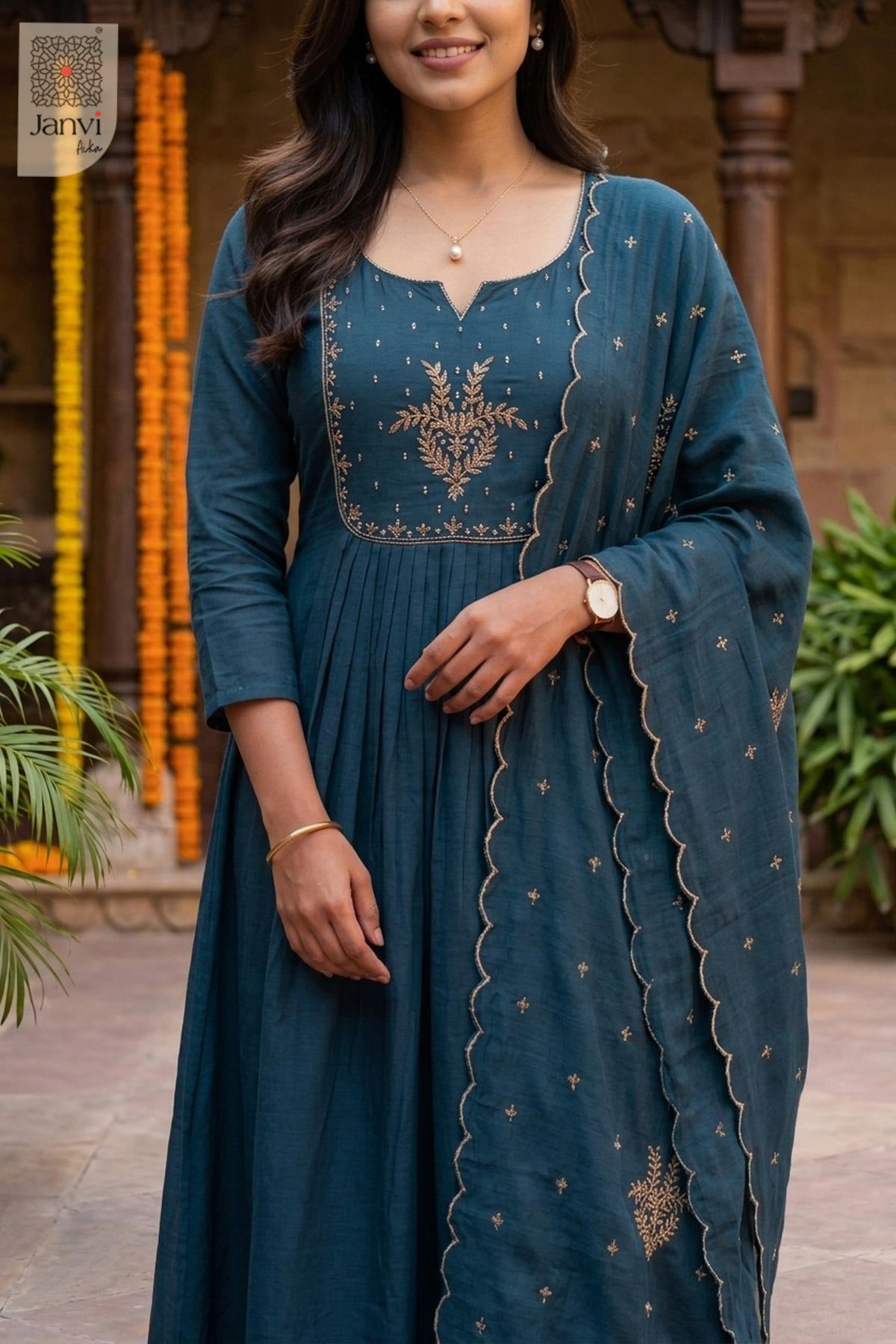 Front close up portrait of gold floral yoke embroidery on a teal blue anarkali kurta.