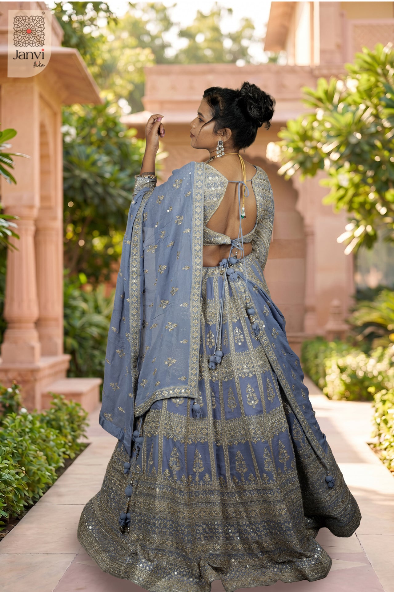 Rear full standing shot of a classic lavender georgette wedding wear lehenga design.