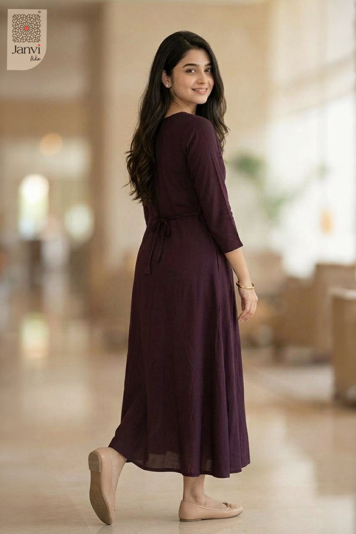 Rear view of dark magenta flared ladies 3 4 sleeve tops with back waist tie indoors