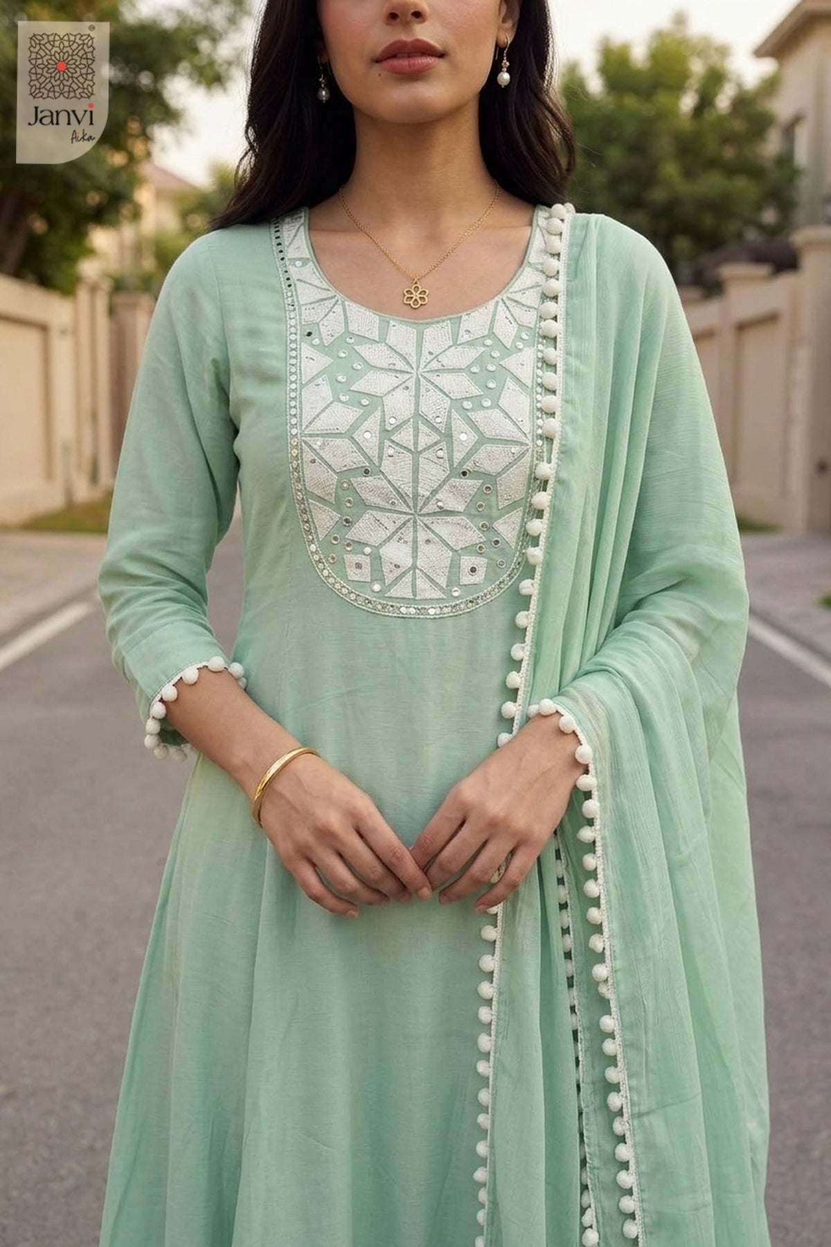 Close up front shot of white mosaic threadwork on a soft cyan silk churidar set.