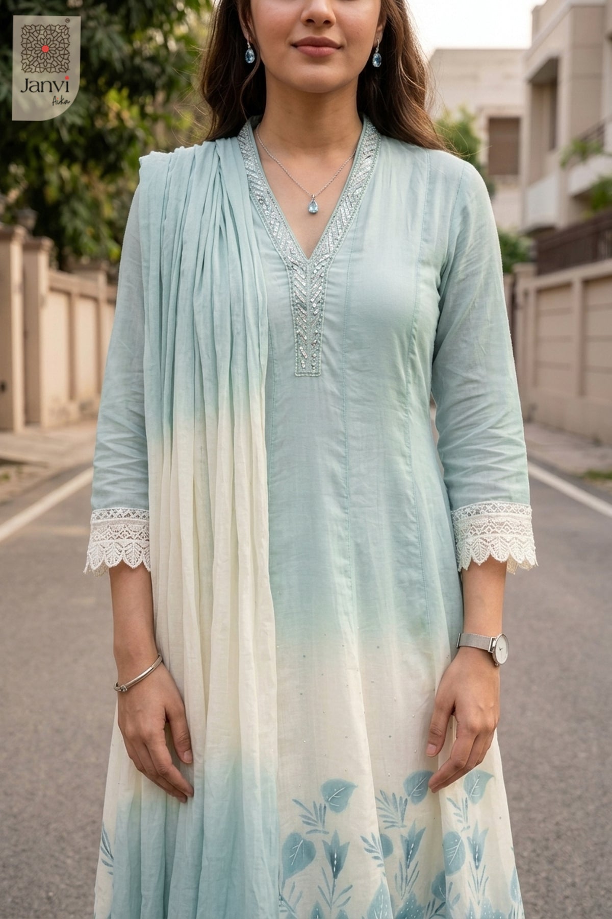 Close up portrait of silver lace neckline on an ice blue georgette anarkali kurti.