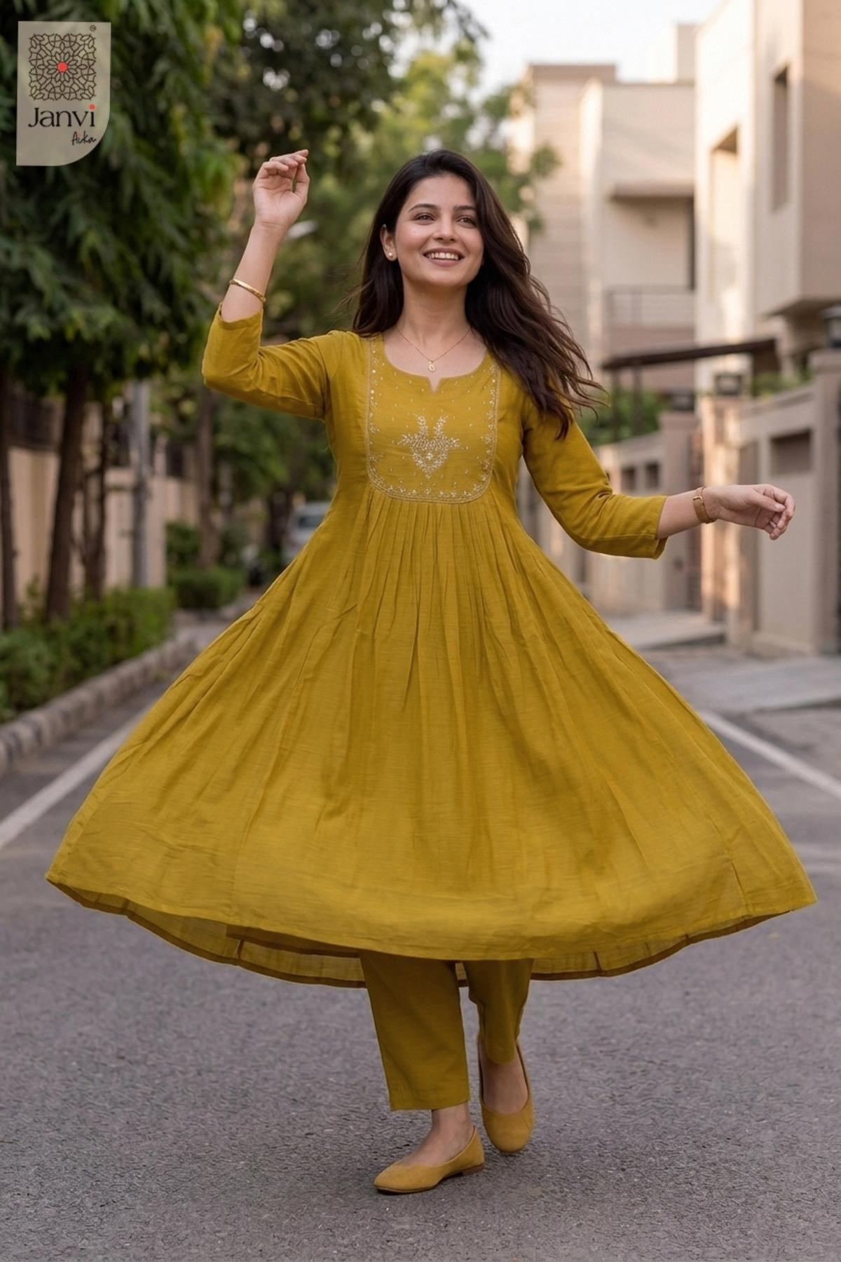 Dynamic twirl motion showing the pleated mustard yellow flare of an anarkali style lehenga.