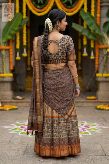 Rear full standing shot of a half saree as a beautiful half lehenga for weddings.