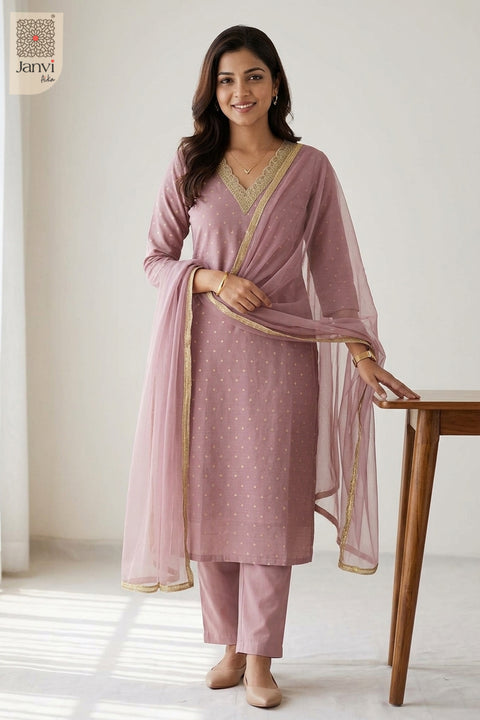 Poised standing shot glancing sideways in an artistic designer party wear churidar.