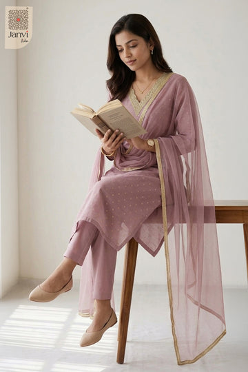 Relaxed lifestyle pose reading an open book wearing a floral churidar set readymade.