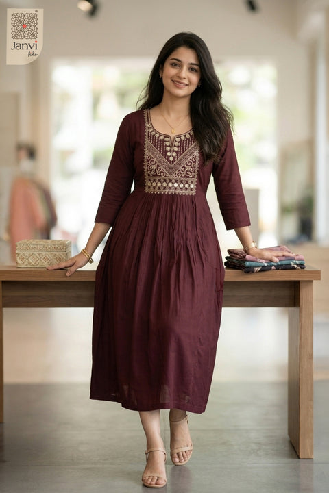 Very dark red flared party wear tops for women styled with hand resting on wood table