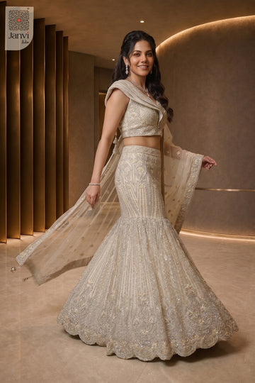 Walking side profile shot of a classic half white net lehenga design.