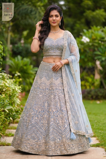 This front full standing shot showcases a gorgeous ice blue net lehenga for weddings.