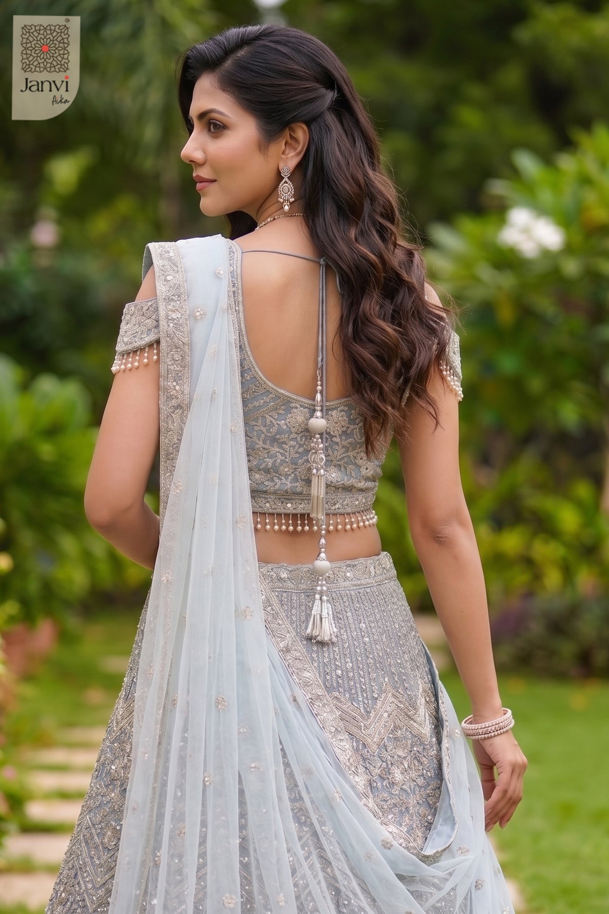 Charming sadi se lehenga design showing a lovely waist up rear keyhole neck in a ice blue net style.