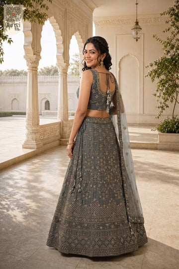 Rear full standing shot of a classic grey net pastel color lehenga design for upcoming festivals.