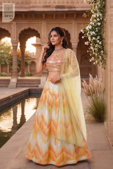 This front full standing shot showcases a gorgeous yellow/orange organza yellow bridal lehenga.
