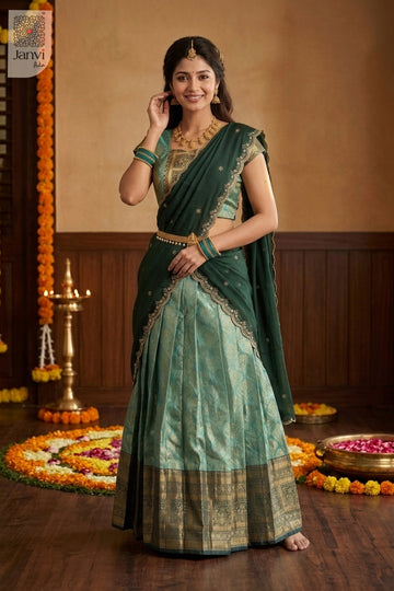 Model in jade green designer lehenga saree with scalloped embroidered dupatta.