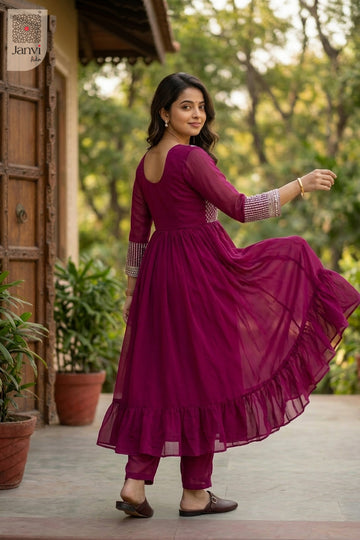 Front angled view of the flared silhouette of Mehr Crimson for simple party wear dress for ladies.