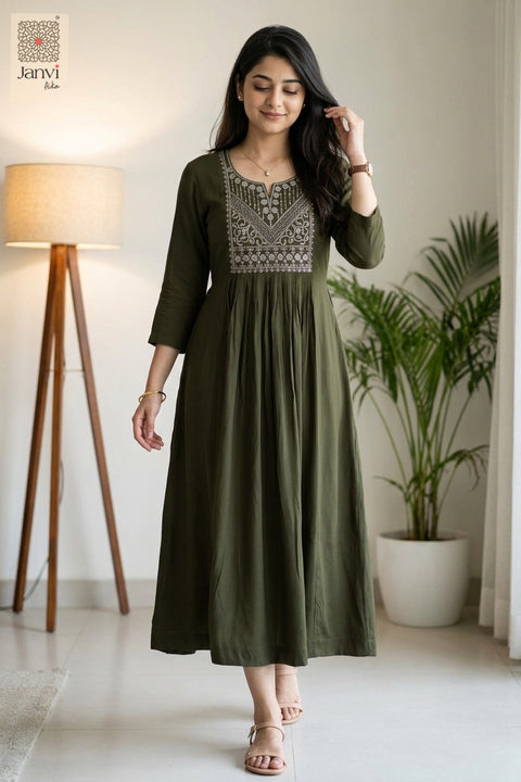 Mid-length front view of desaturated green unique tops for women with yoke stitching