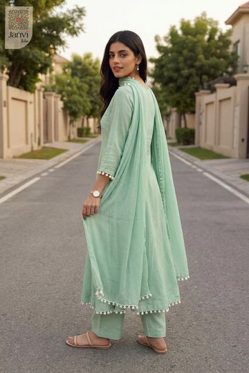 Outdoor rear angle glancing over shoulder in a soft cyan churidar sleeves kurti.