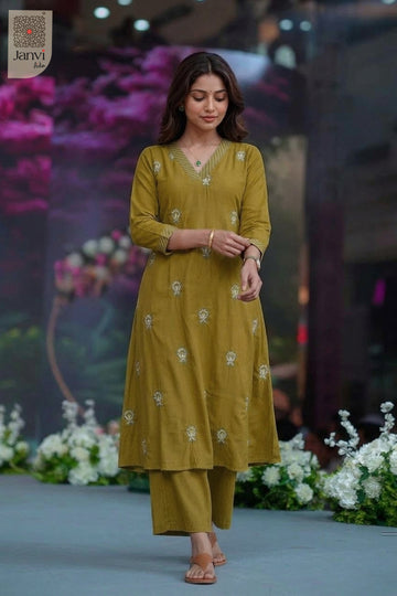 Front studio portrait with clasped hands in an embroidered moss indo western dress for women.