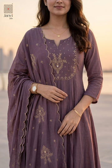 Close up portrait of gold yoke embroidery on a dark lavender short anarkali kurti.