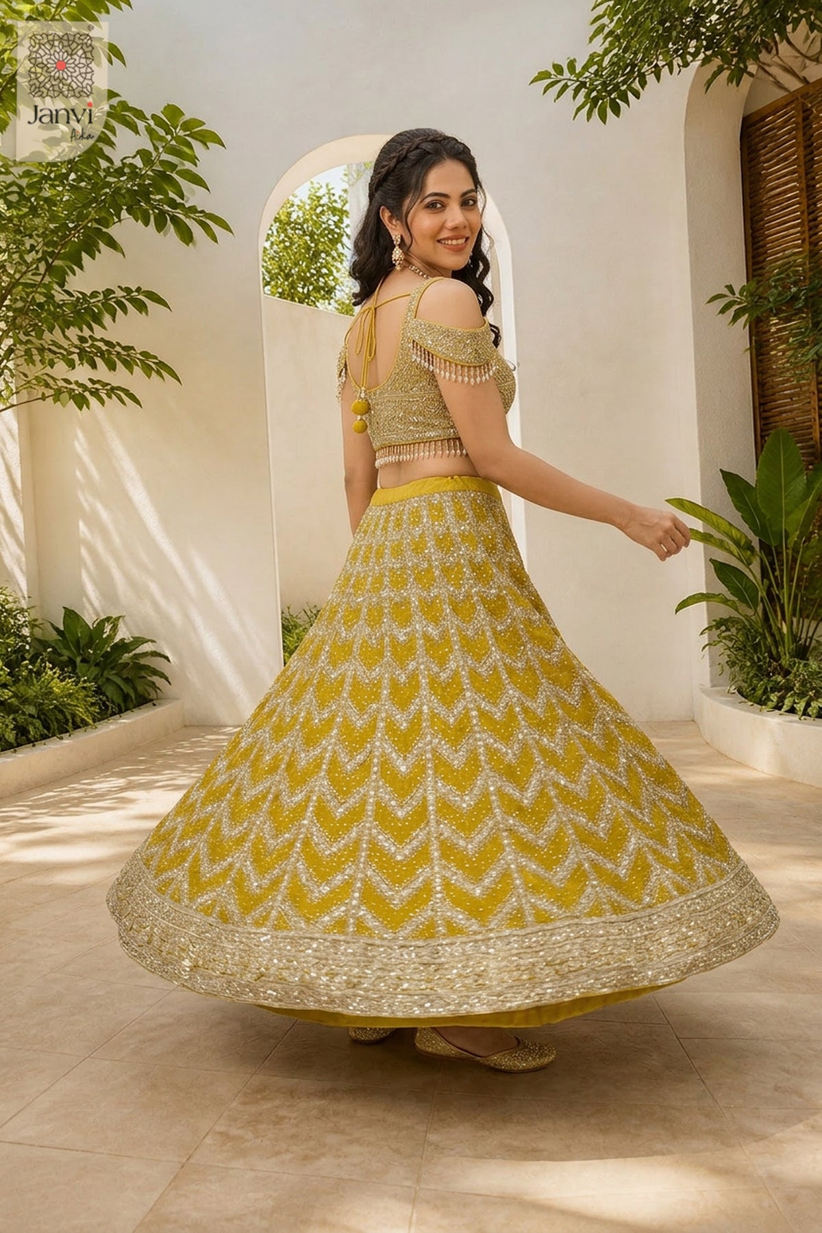 Rear full standing shot of a classic mustard gold georgette and net lehenga skirt with blouse design.