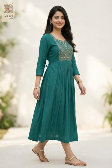 Side portrait of smiling woman in dark cyan dressy tops for women in garden background