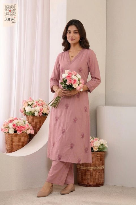 Studio portrait holding flower bouquet in a printed matching floral indo western dress for women.