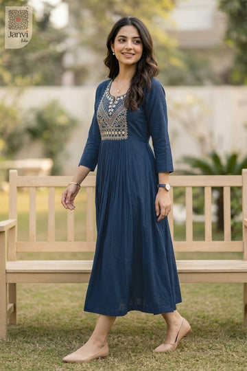 Model standing by garden bench in naval night 3 4 sleeve tops for women in flared cut