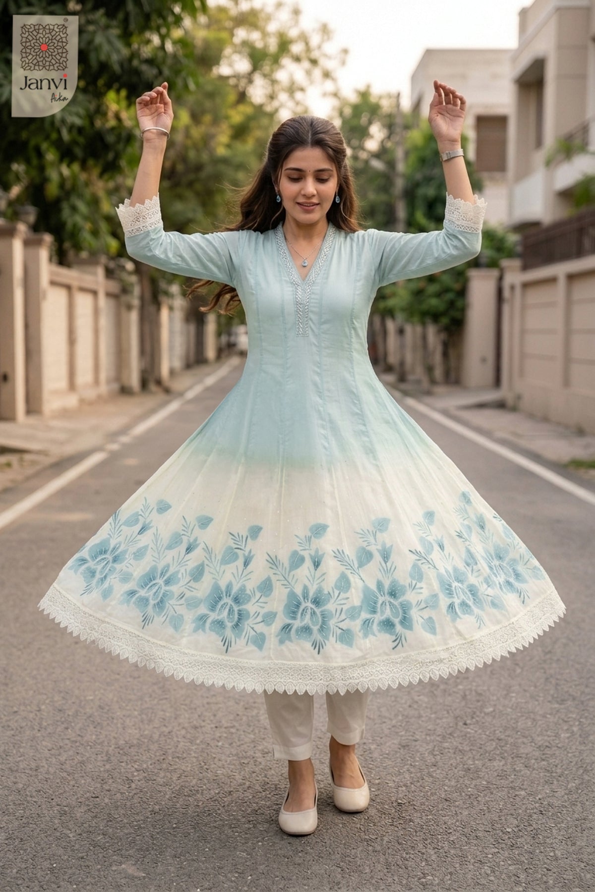 Whirling twirl motion showing the wide ice blue flare of a georgette anarkali dress.