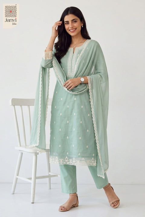 Standing pose with hand resting on a white chair in a lavender party wear churidar.