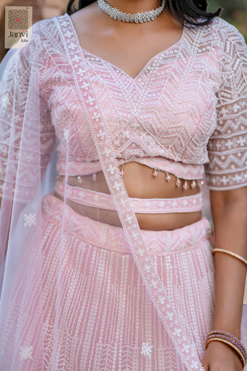 Stunning pink net lehenga for women traditional with an exquisite front neck close up.