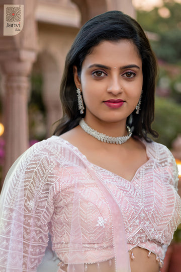 An exquisite olive lehenga with front neck close up in a premium pink net design.