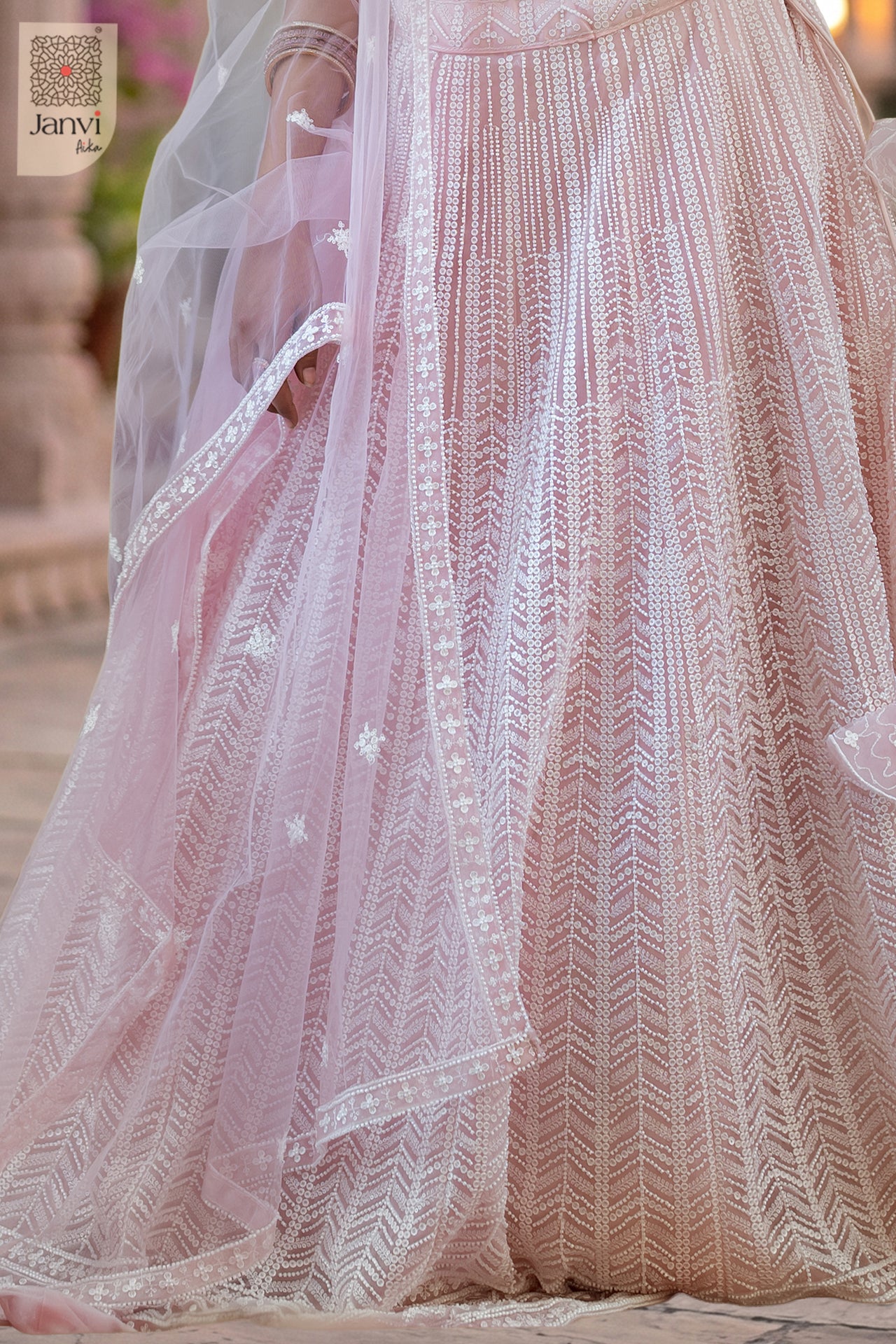 Charming saree worn as lehenga showing a lovely fabric weave close up view in a pink net style.
