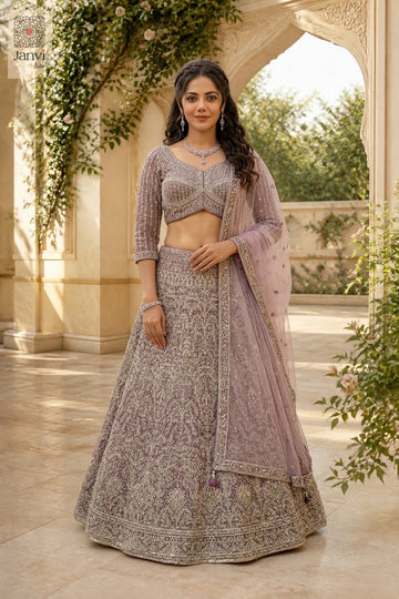 This front full standing shot showcases a gorgeous onion peel net satin silk lehenga for weddings.
