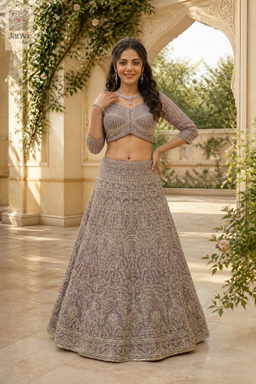Charming designer lehenga choli showing a lovely front full standing shot in a onion peel net style.