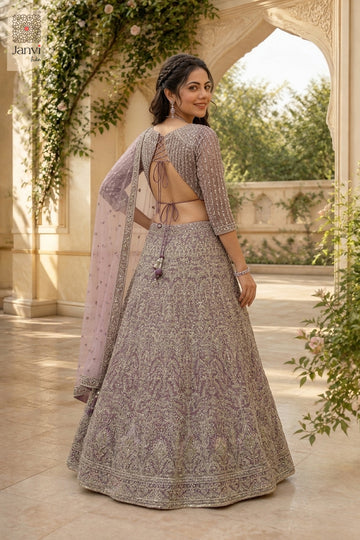 Charming buy lehenga showing a lovely rear full standing shot in a onion peel net style.