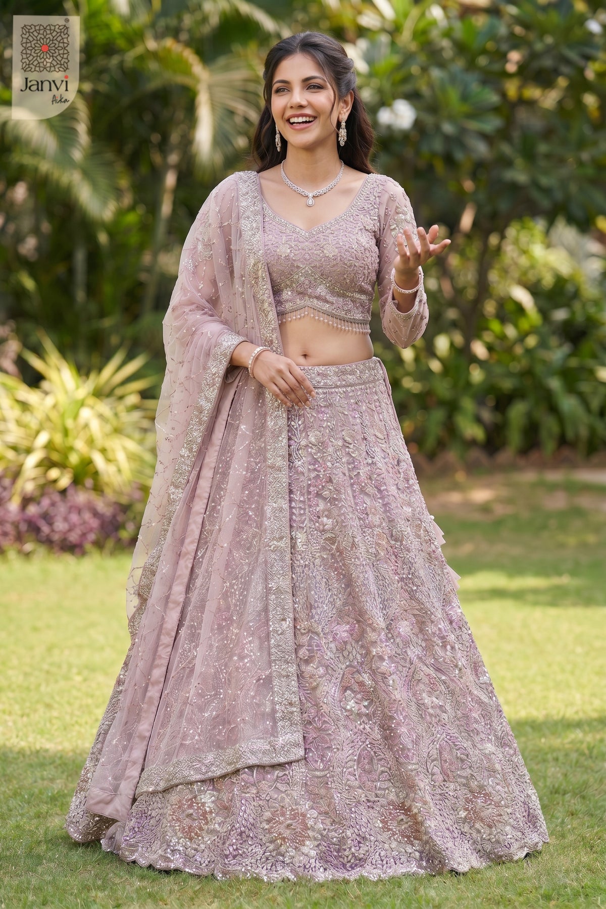 Front full standing shot of a beautiful rose gold/dusty lilac net lehenga with rose dupatta.