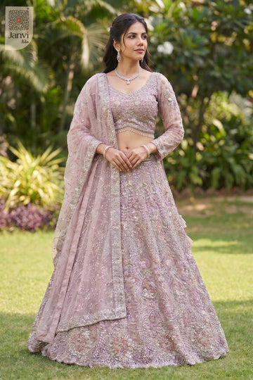 Front full standing shot of a classic rose gold/dusty lilac net lehenga ki design design.