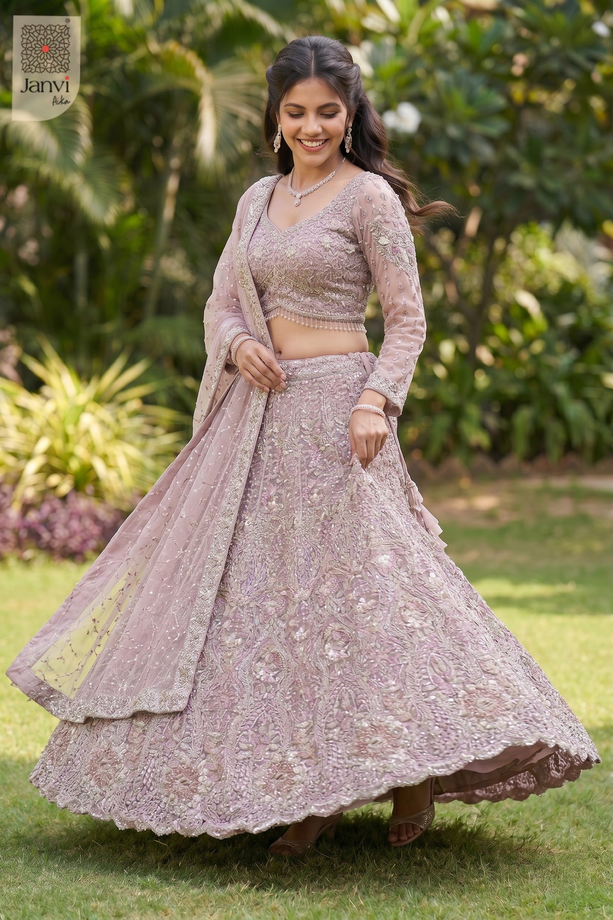 Standing side profile shot of a beautiful rose gold/dusty lilac net set saree lehenga.
