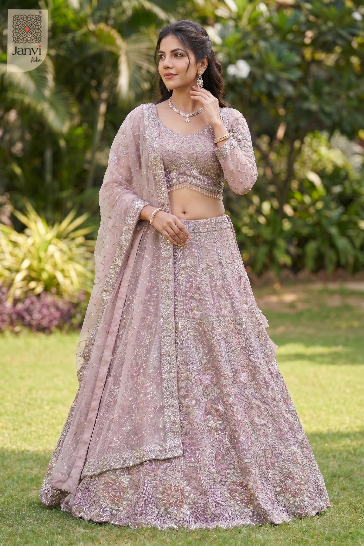 This front full standing shot showcases a gorgeous rose gold/dusty lilac net rose colour lehenga.