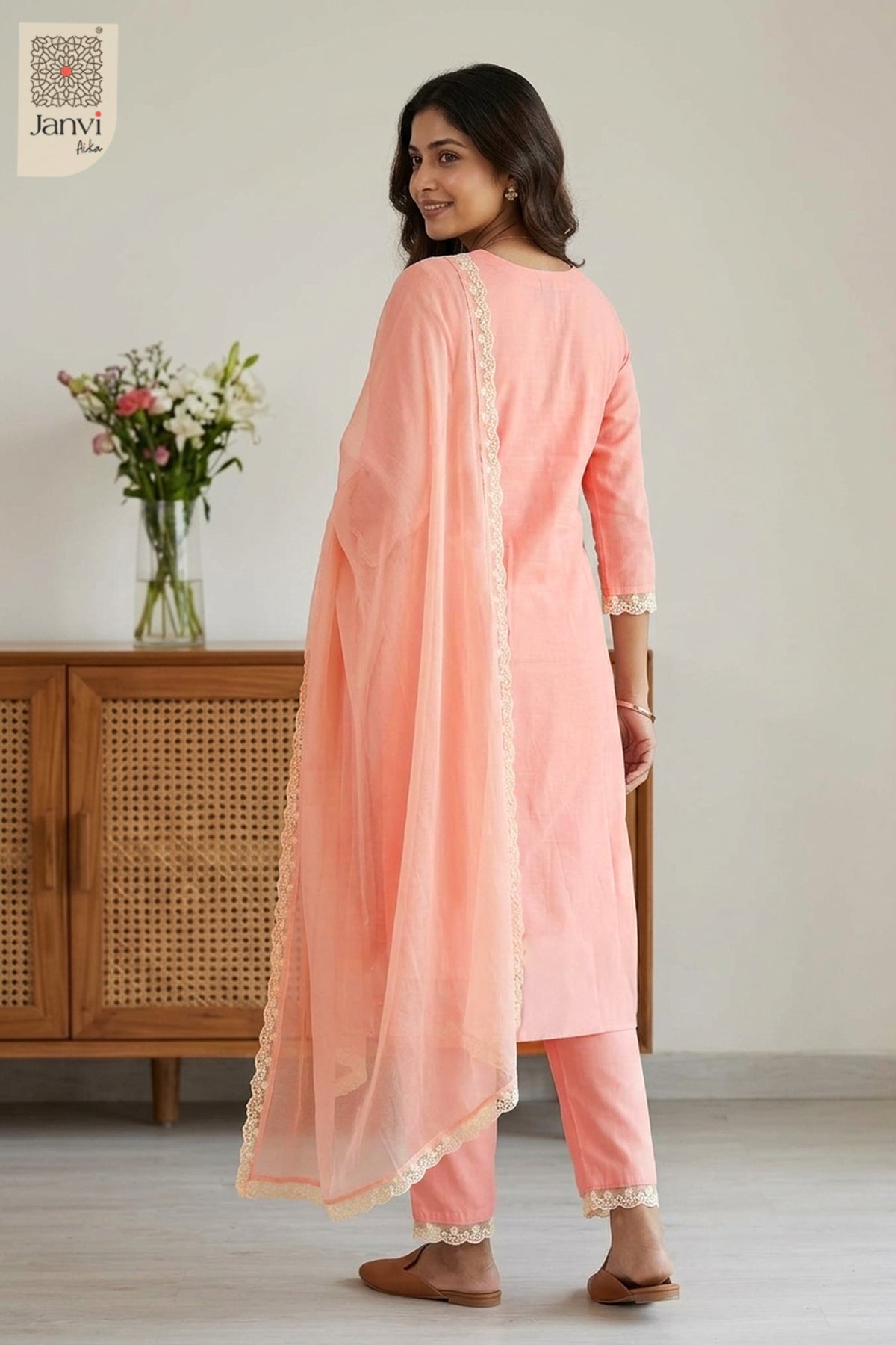 Rear view showing sheer dupatta drape and back fit of a peach churidar sleeves kurti.