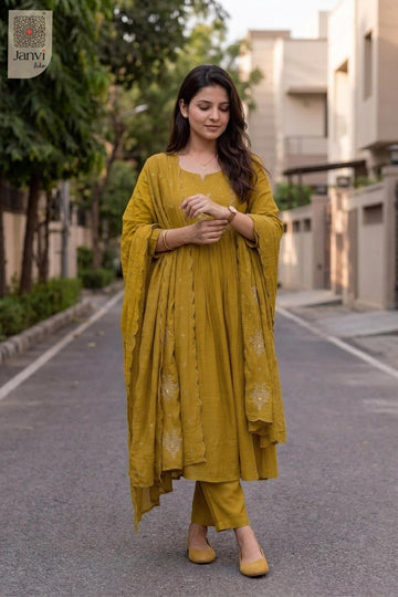 Outdoor walking sequence pose in a festive mustard yellow flared anarkali kurta set.