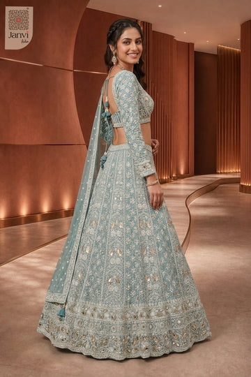 Rear full standing shot of a classic seafoam green georgette navratri ghagra choli design.