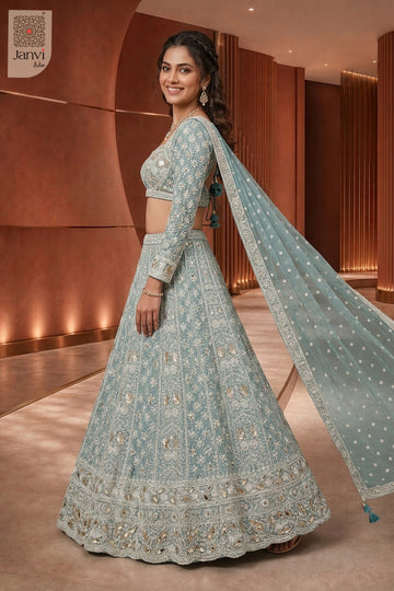 Standing side profile shot of a classic seafoam green georgette saree ghagra style design.
