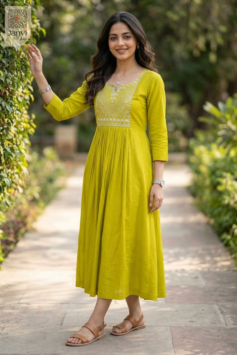 Standing near garden hedge in moderate yellowish green party wear tops for women pose