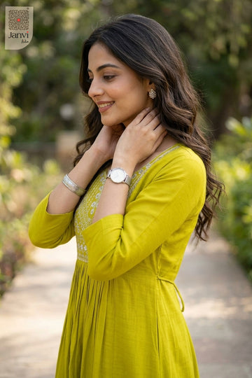 Side portrait in moderate yellowish green beautiful tops for ladies touching necklace