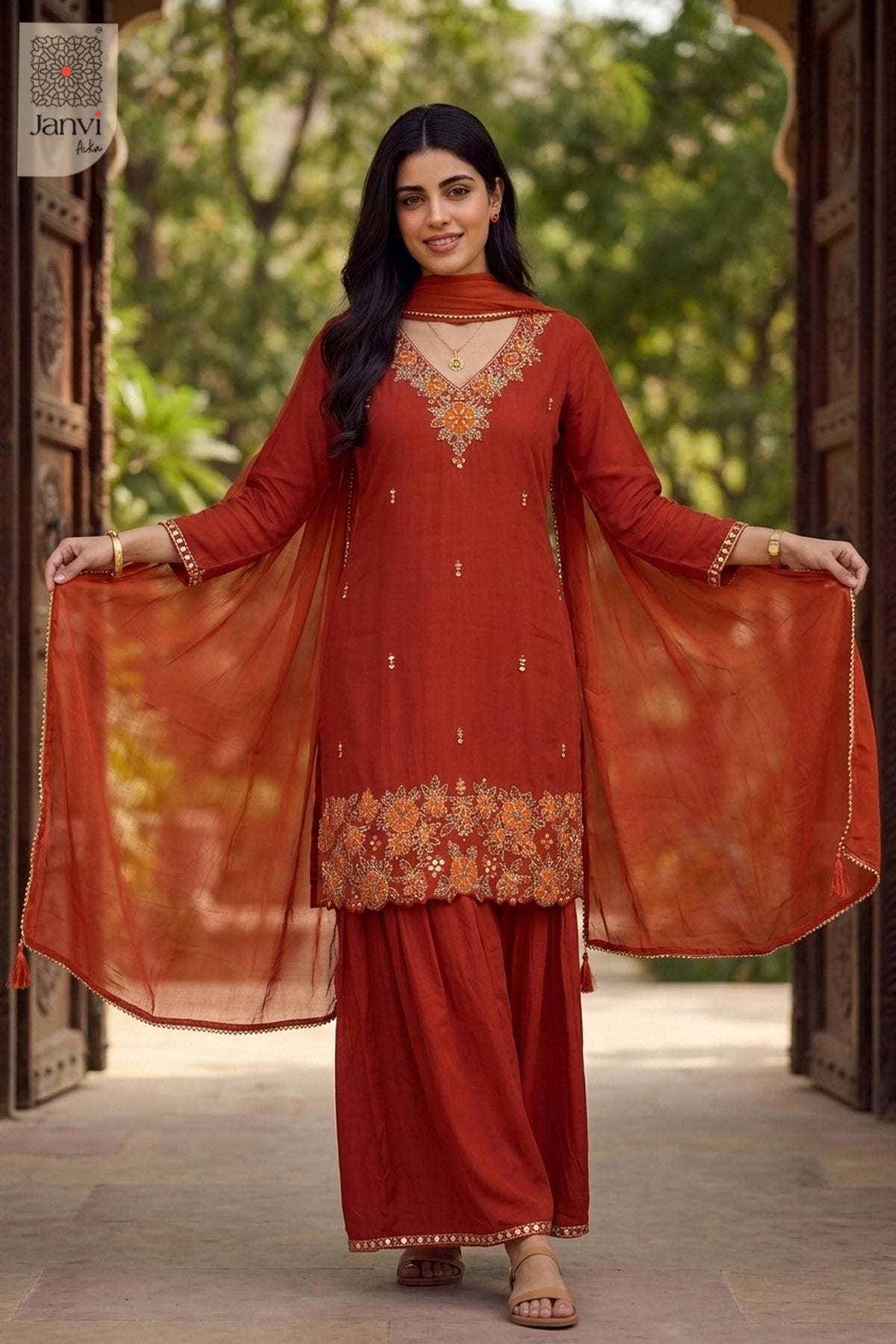 Front standing studio view of an orange festive georgette anarkali kurti and pants.