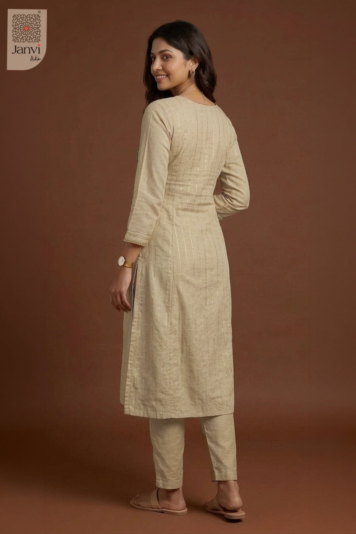Studio back view highlighting tailored silhouette of grayish orange churidar sleeves kurti.