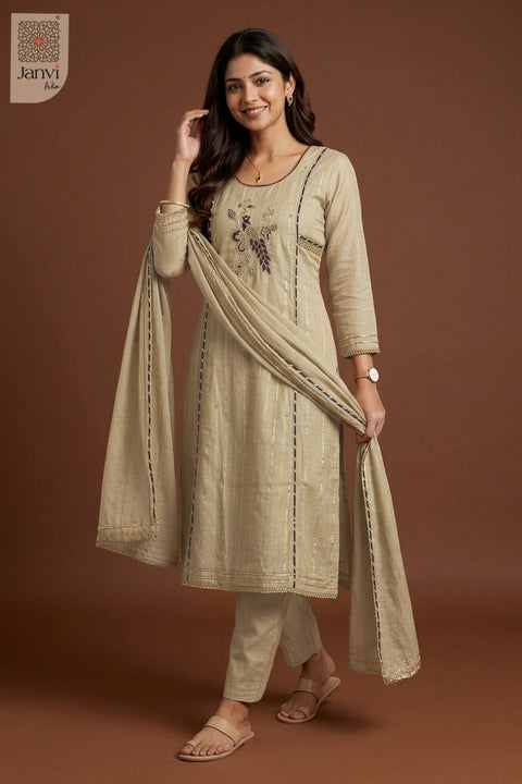 Front standing pose holding drape in elegant grayish orange churidar set with dupatta.