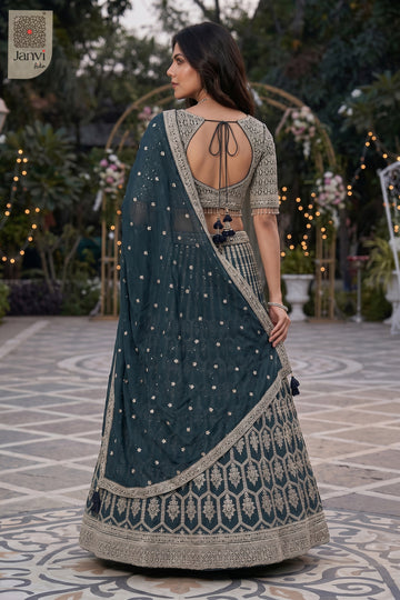 Rear full standing shot of a classic bottle green georgette lehenga choli with long blouse design.