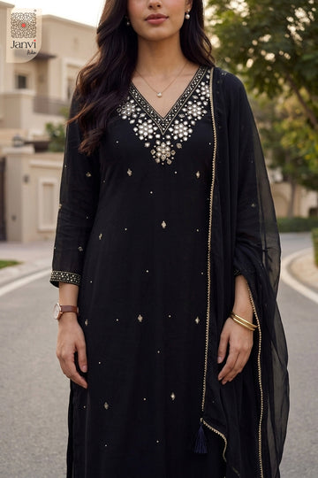 Close up portrait of V neck mirror embroidery on a black short anarkali kurti set.