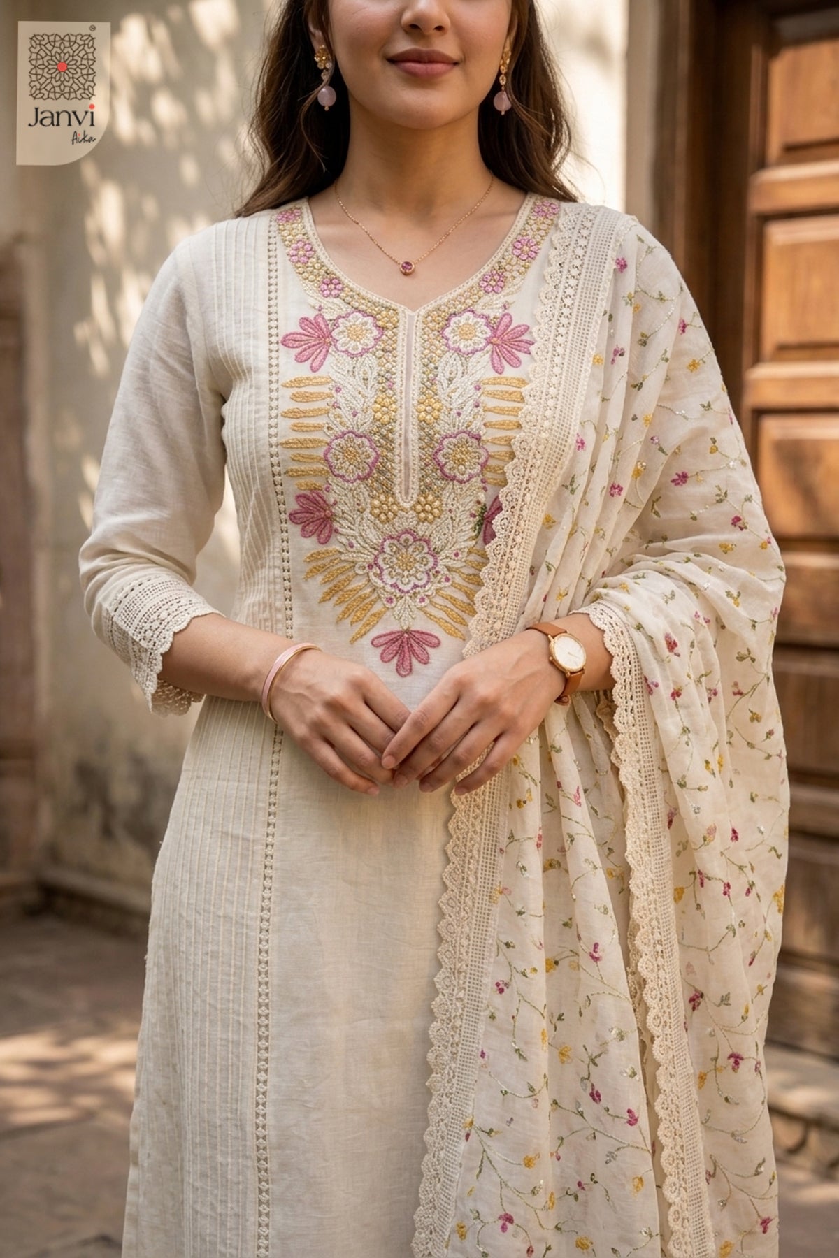 Close up view of floral embroidery on a half white short anarkali kurti neckline.