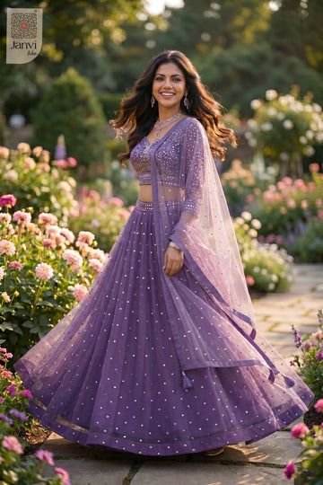 Stunning purple net lehenga choli with sleeves with an exquisite standing side profile shot.